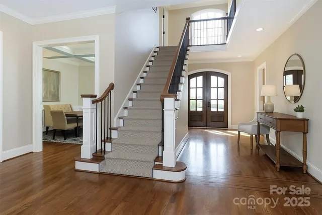 a view of entryway and hall with wooden floor