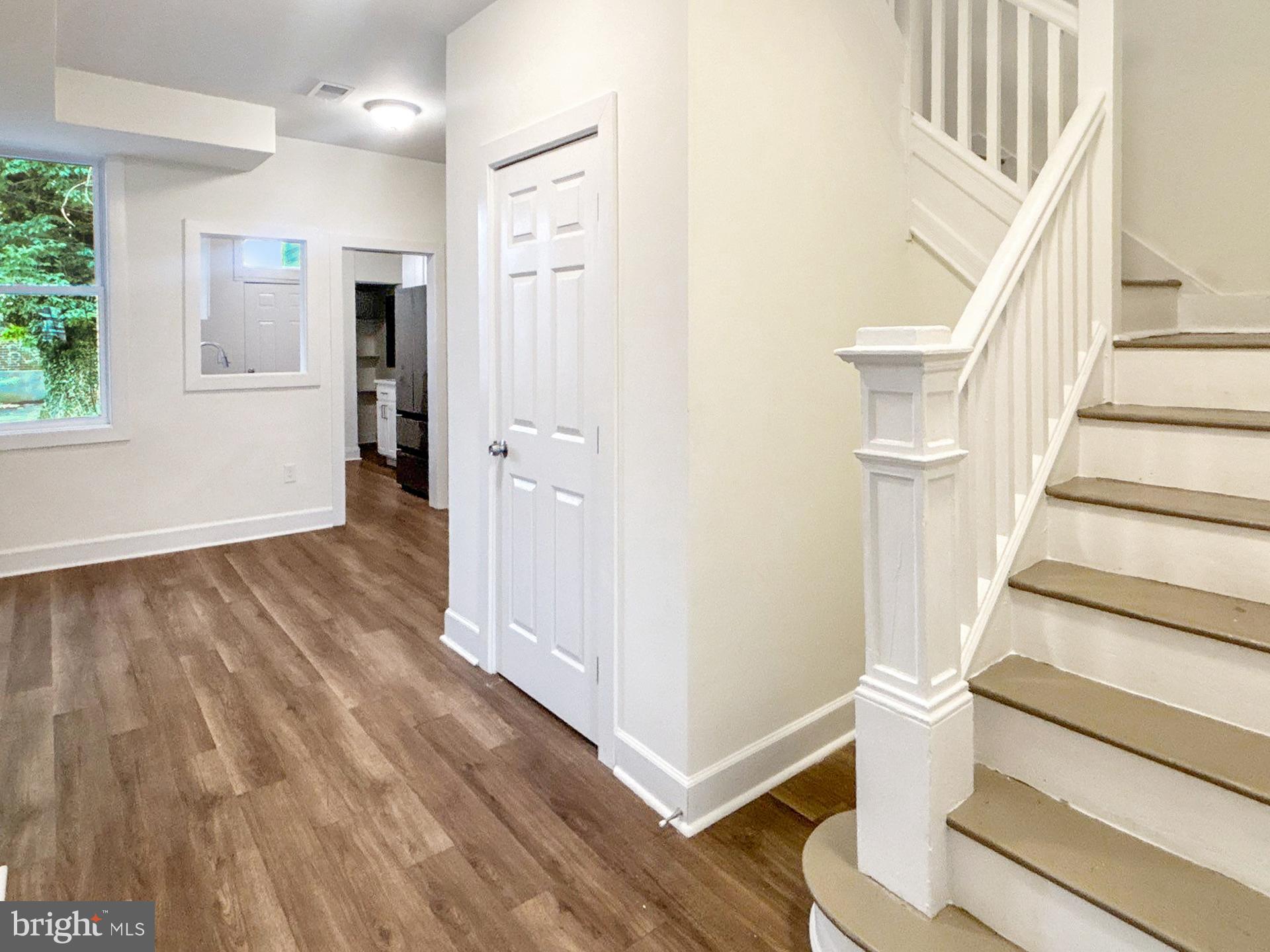 2217 Riggs Avenue Baltimore, MD 21216 - Photo 11 of 26 a view of entryway with wooden floor and stairs