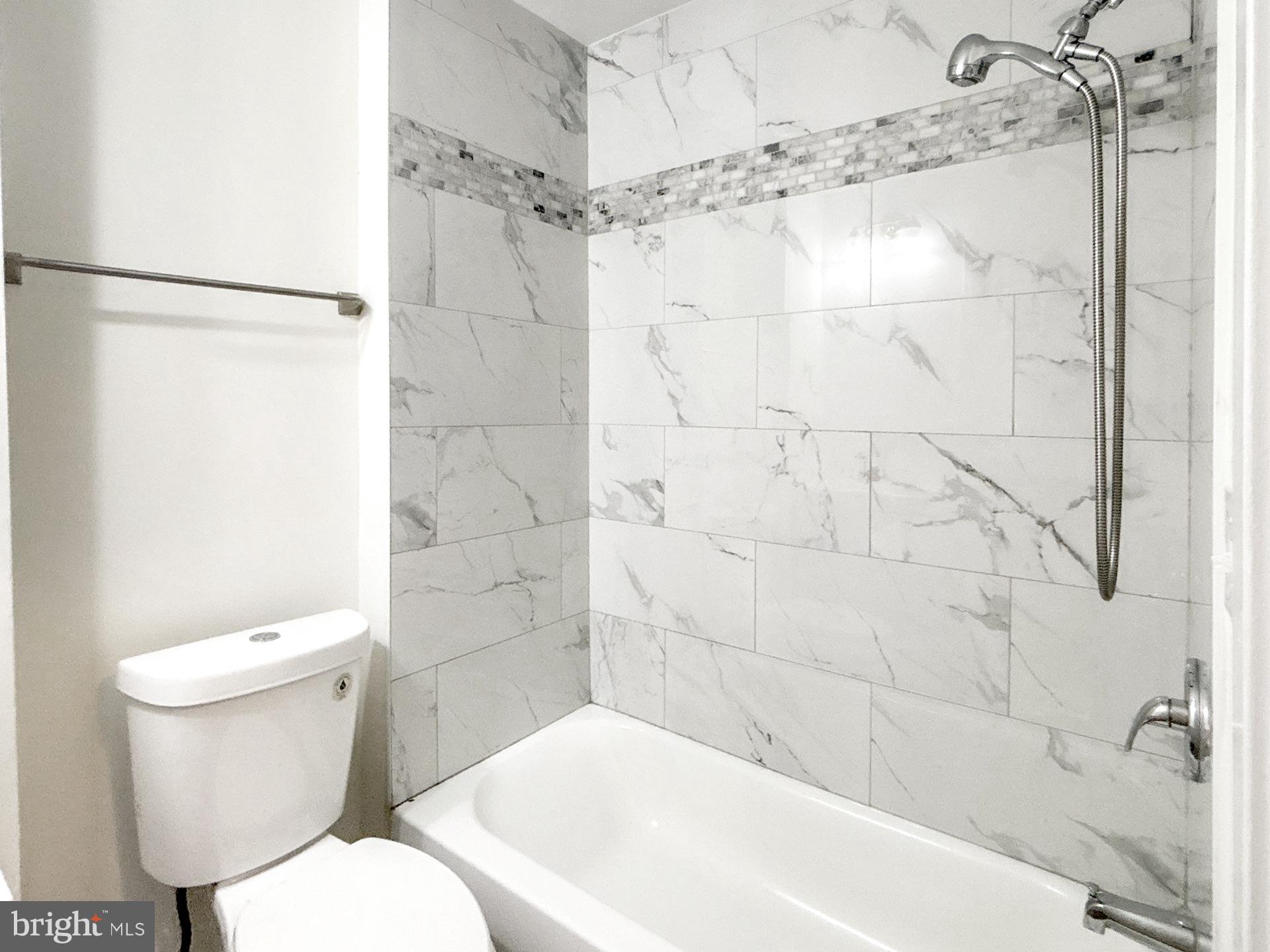 2217 Riggs Avenue Baltimore, MD 21216 - Photo 13 of 26 a bathroom with a toilet and shower