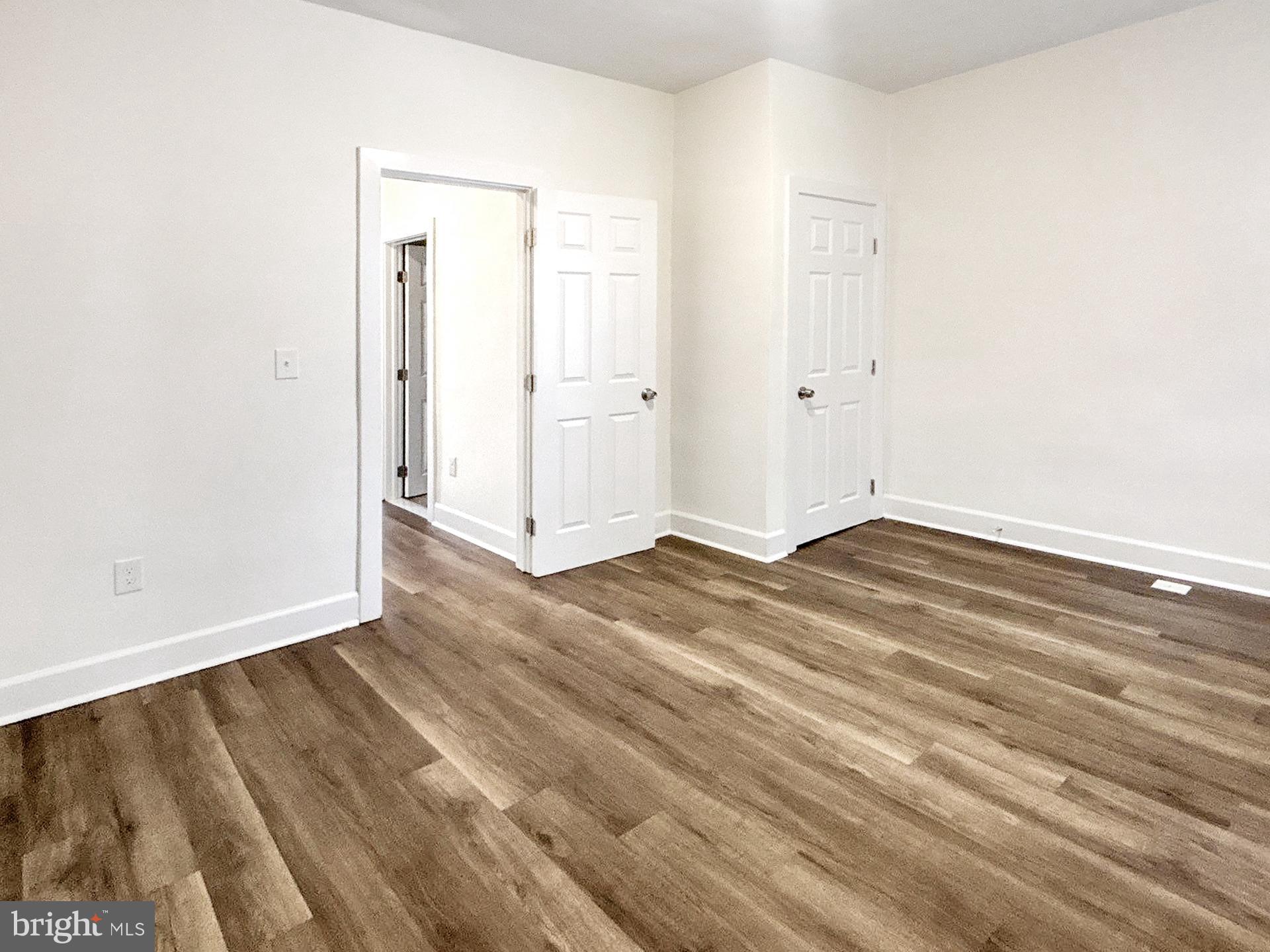 2217 Riggs Avenue Baltimore, MD 21216 - Photo 15 of 26 an empty room with wooden floor