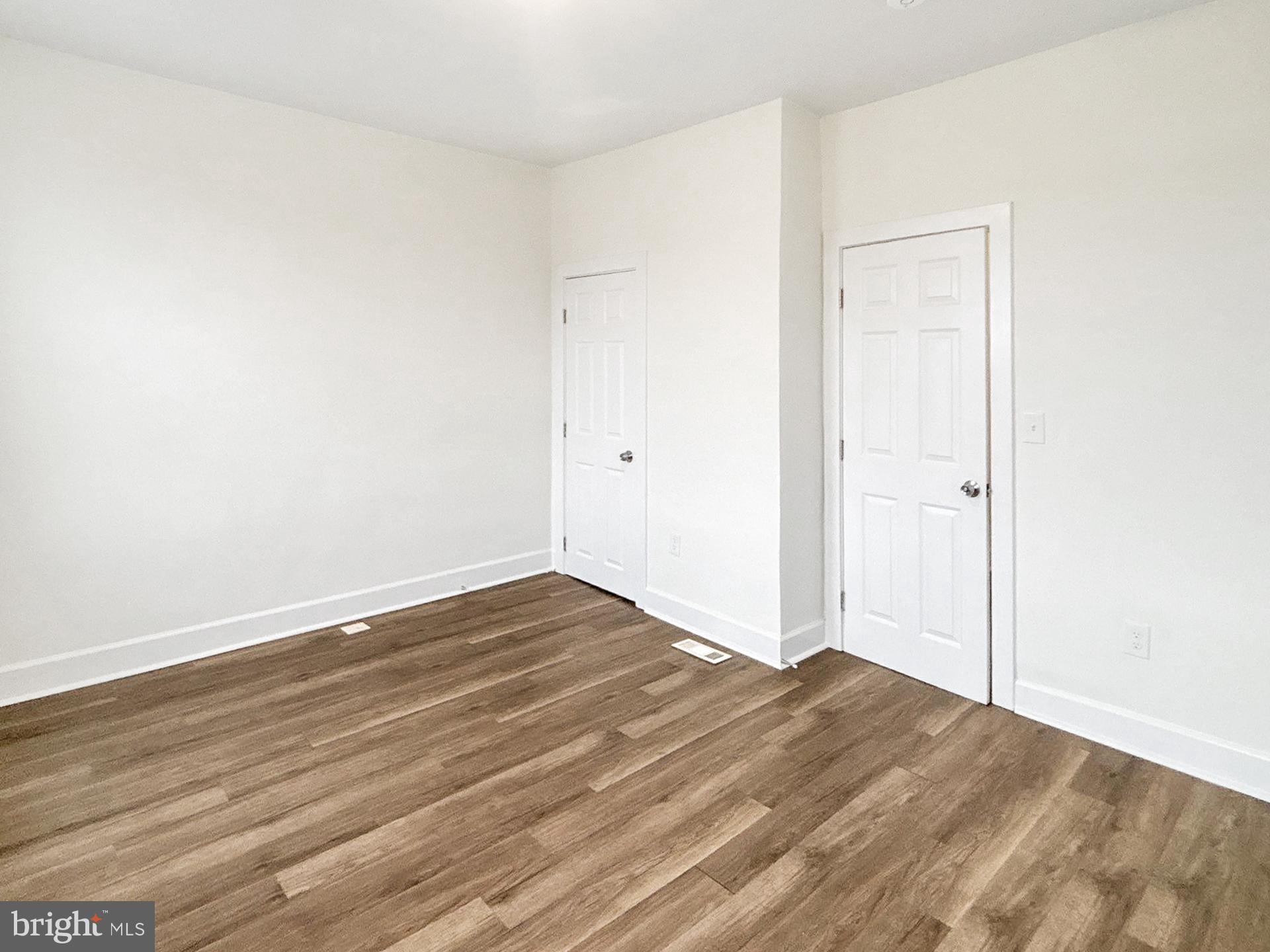 2217 Riggs Avenue Baltimore, MD 21216 - Photo 18 of 26 an empty room with wooden floor