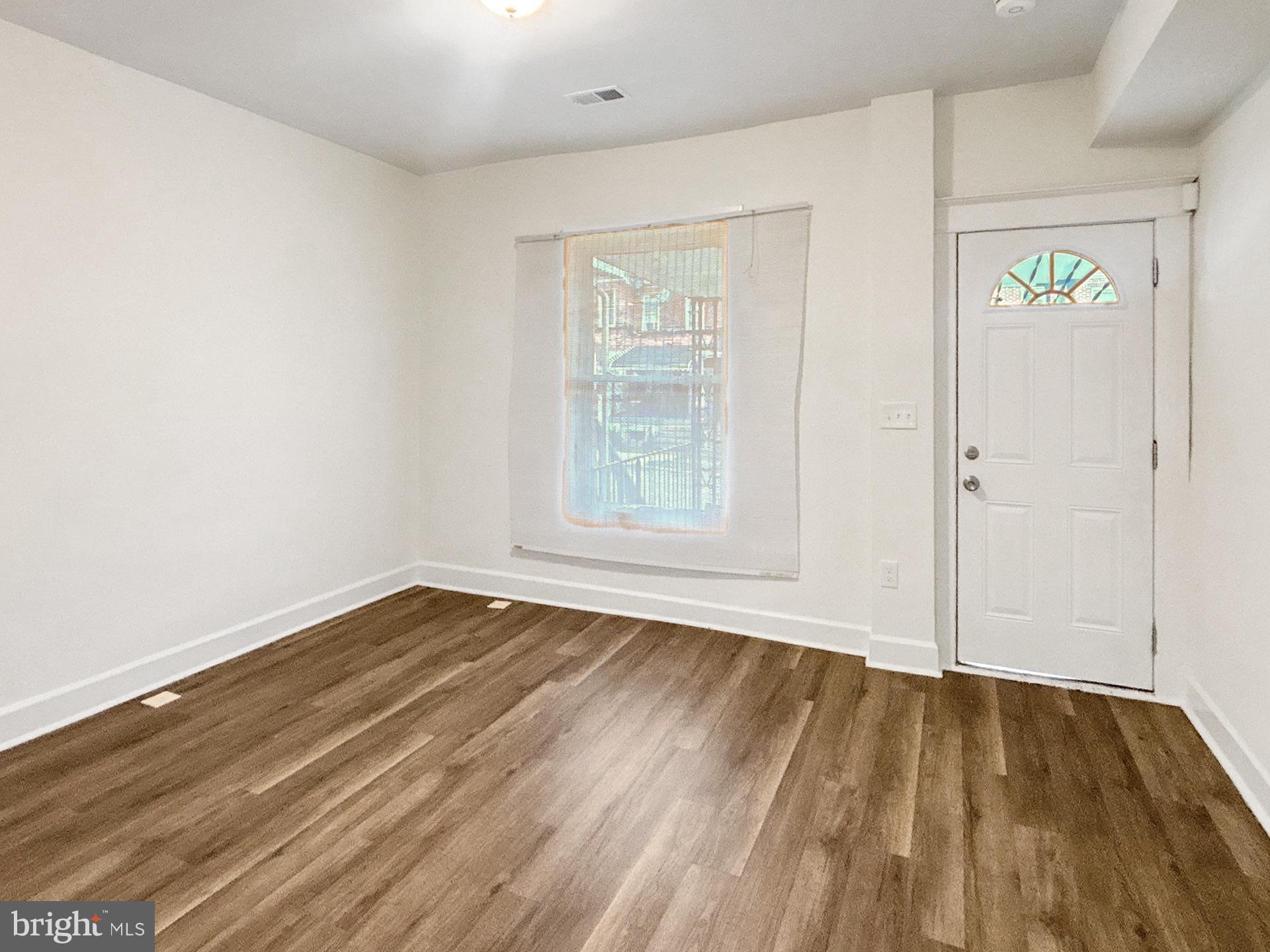 2217 Riggs Avenue Baltimore, MD 21216 - Photo 2 of 26 wooden floor in an empty room