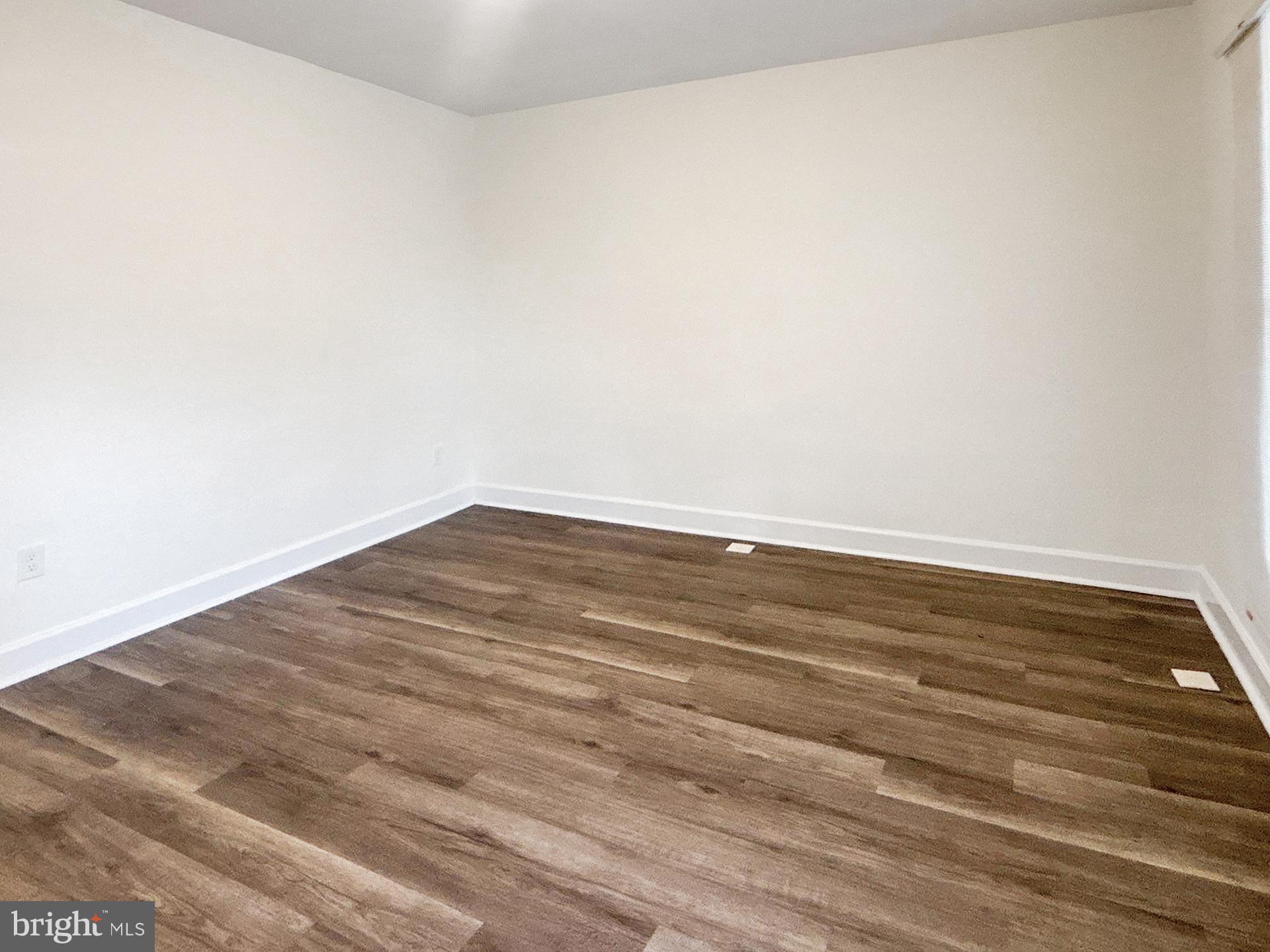 2217 Riggs Avenue Baltimore, MD 21216 - Photo 3 of 26 a view of empty room with wooden floor