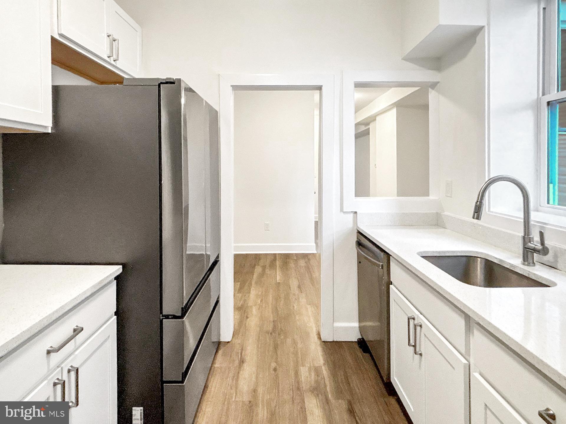 2217 Riggs Avenue Baltimore, MD 21216 - Photo 5 of 26 a kitchen with a refrigerator and a sink