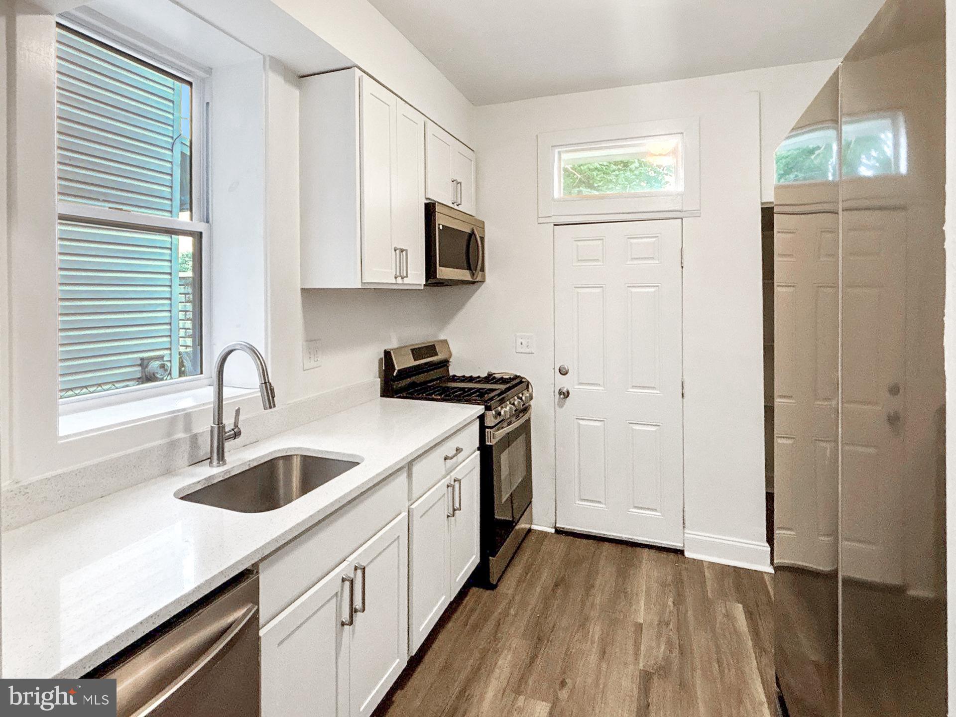 2217 Riggs Avenue Baltimore, MD 21216 - Photo 8 of 26 a kitchen with a sink cabinets and appliances