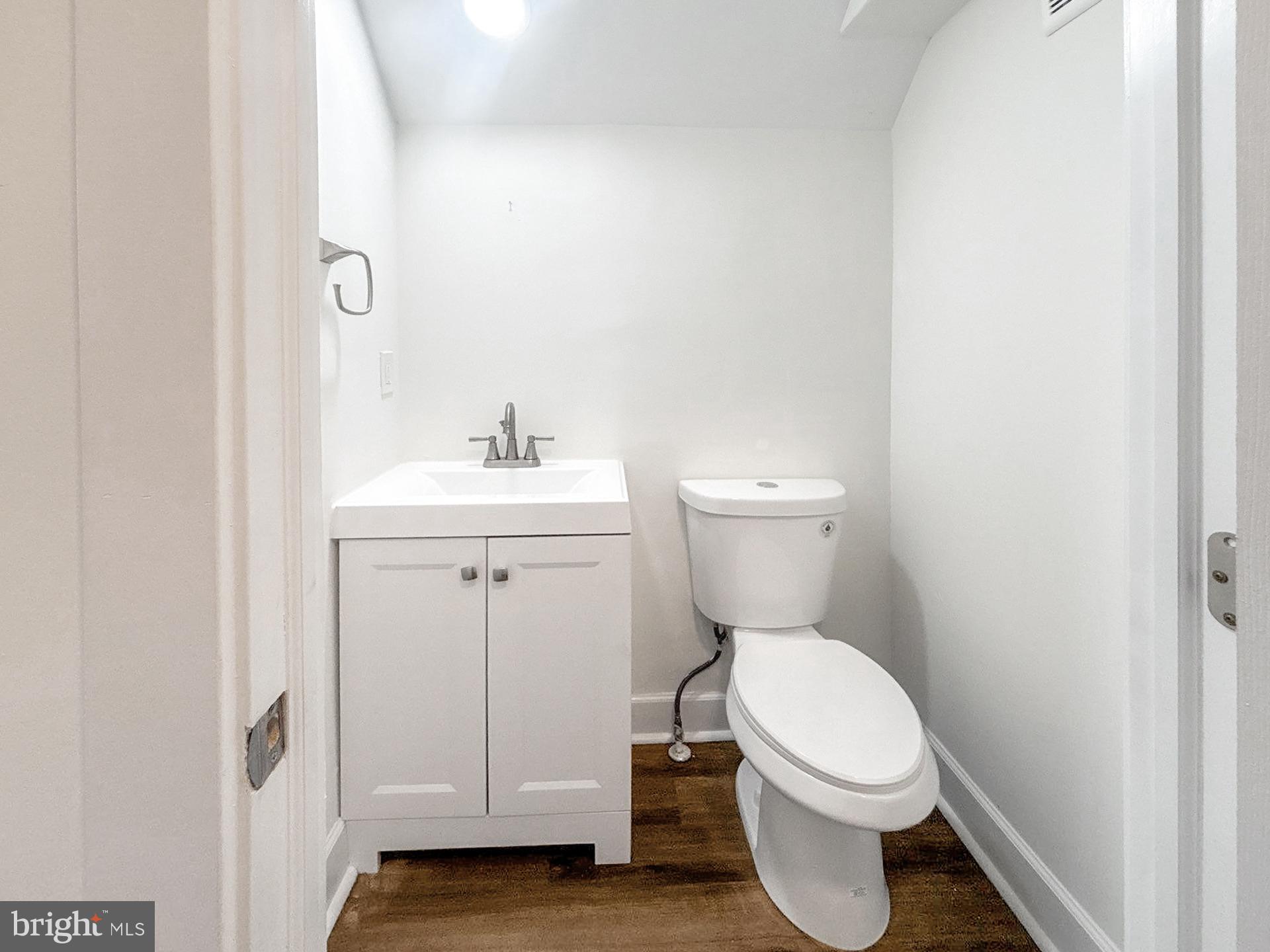 2217 Riggs Avenue Baltimore, MD 21216 - Photo 10 of 26 a white toilet sitting next to a bathroom sink