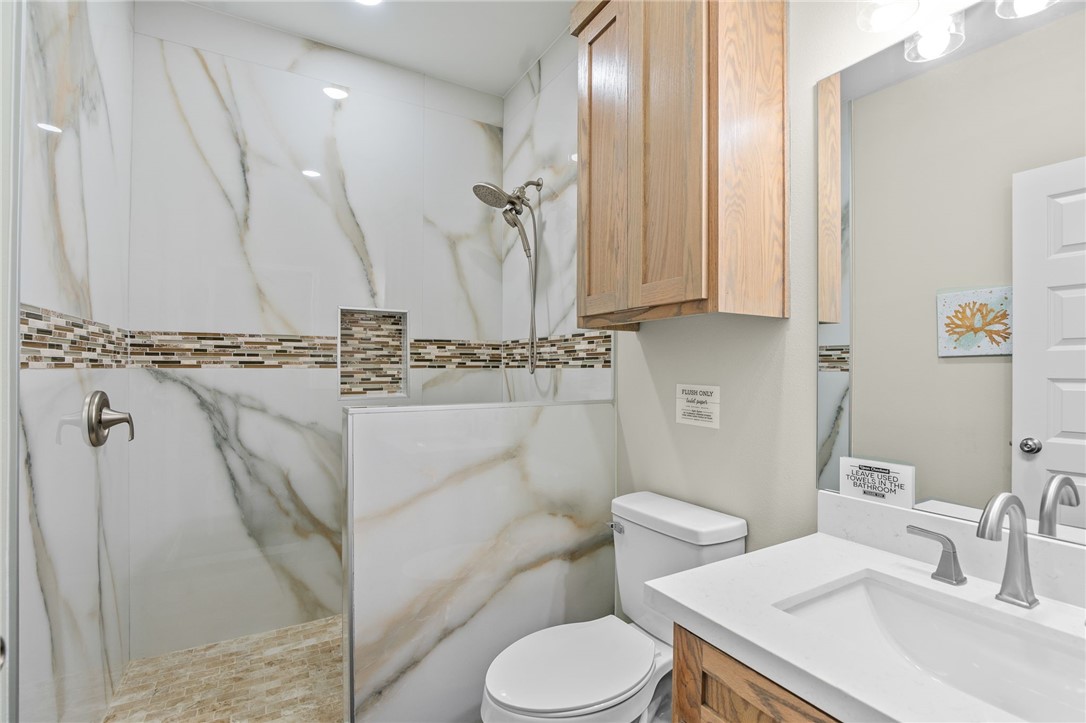 1263 East 2360th Circle Riviera, TX 78379 - Photo 11 of 40 a bathroom with a sink a toilet and a mirror