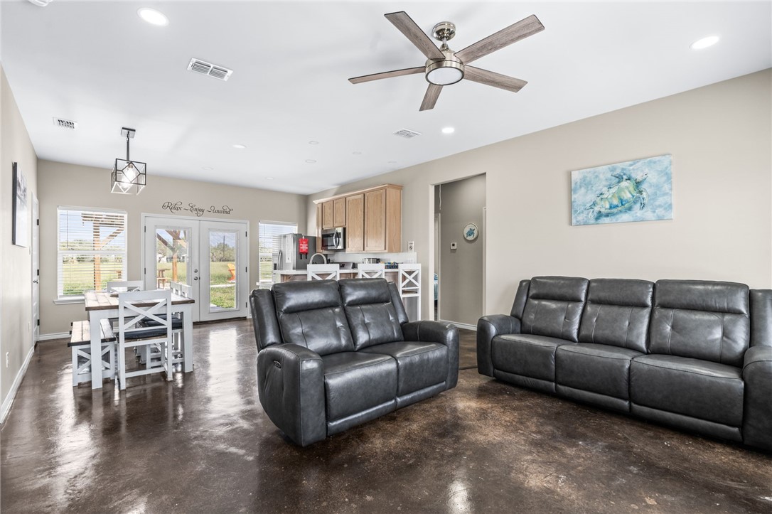 1263 East 2360th Circle Riviera, TX 78379 - Photo 17 of 40 a living room with furniture a ceiling fan a flat screen tv and a window