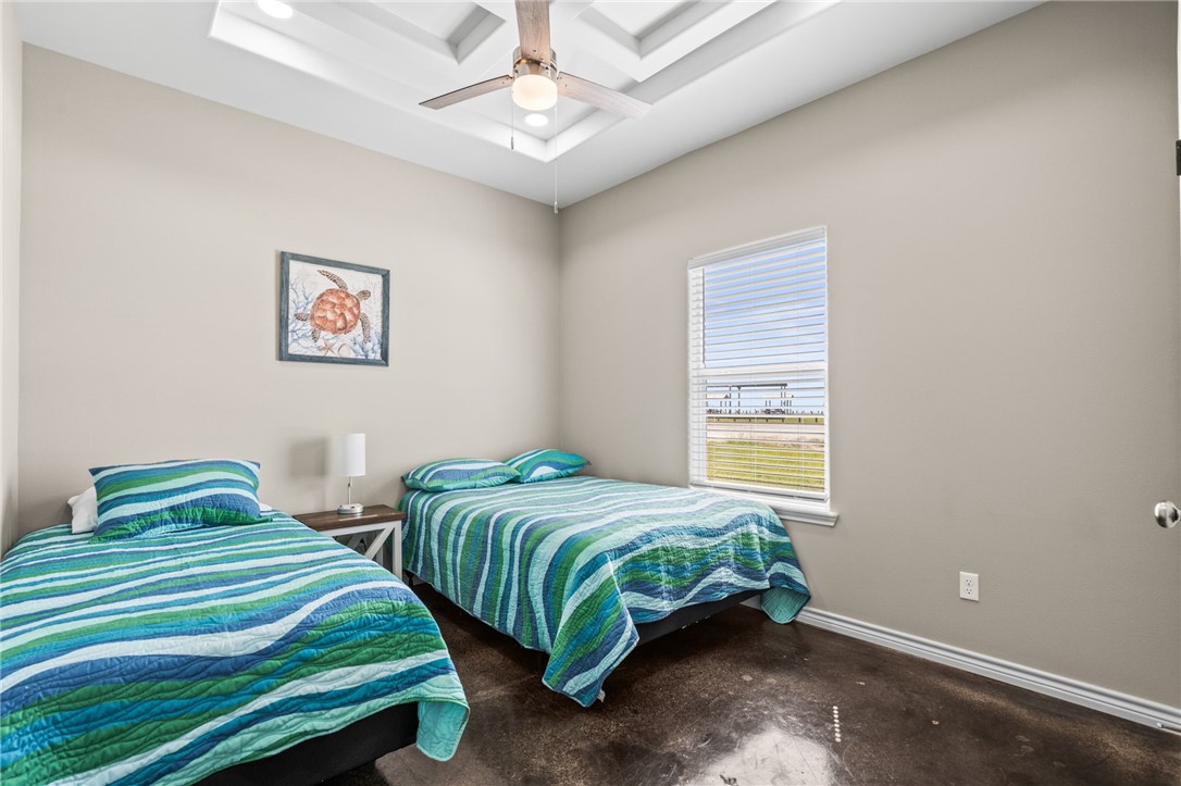 1263 East 2360th Circle Riviera, TX 78379 - Photo 23 of 40 a bedroom with two beds and a chandelier