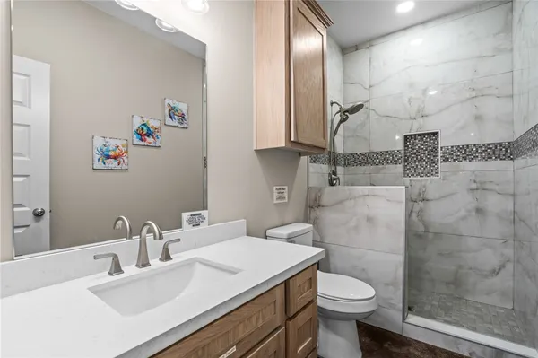a bathroom with a sink toilet and a mirror