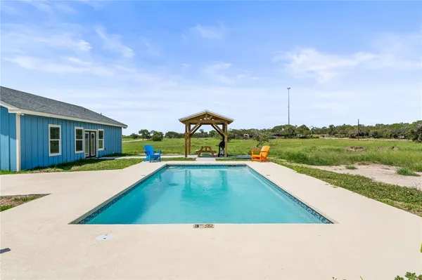 a view of a swimming pool with a lounge chair