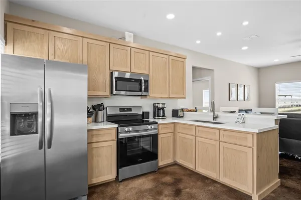 a kitchen with a sink stainless steel appliances and cabinets