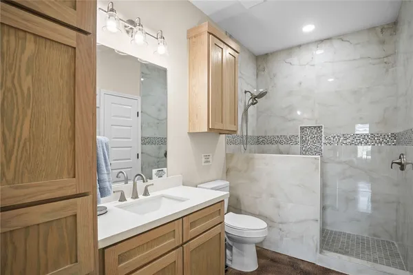 a bathroom with a sink toilet and shower
