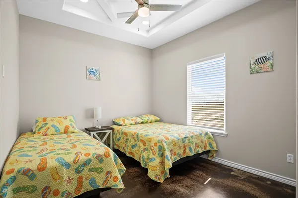 a bedroom with two beds and a window