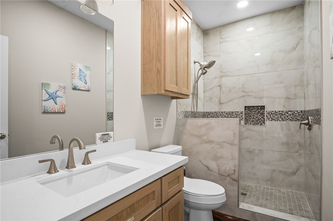 1263 East 2360th Circle Riviera, TX 78379 - Photo 35 of 40 a bathroom with a sink a toilet and shower