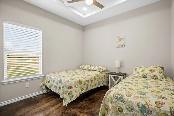 a bedroom with two beds and a window