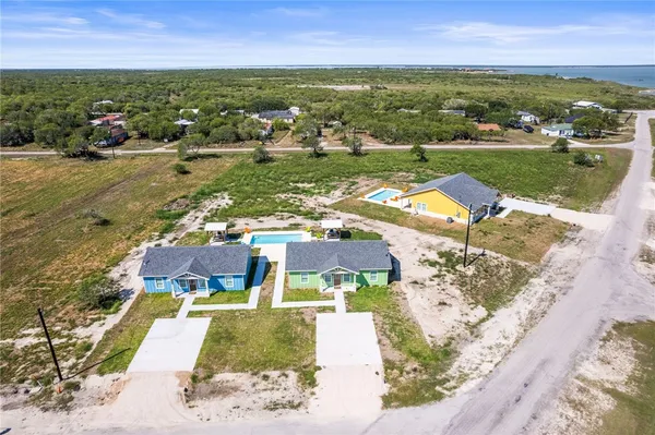 an aerial view of residential houses with outdoor space
