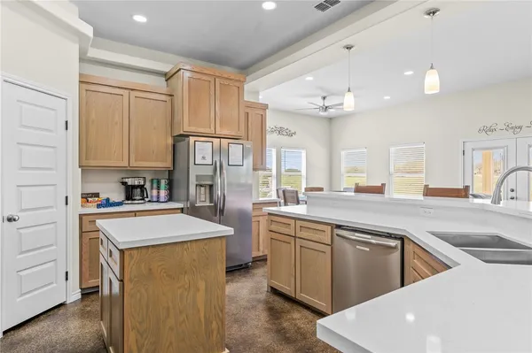 a kitchen with cabinets and stainless steel appliances