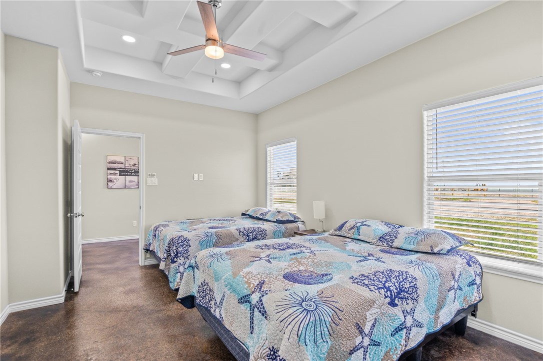 1263 East 2360th Circle Riviera, TX 78379 - Photo 8 of 40 a bedroom with bed and a chandelier