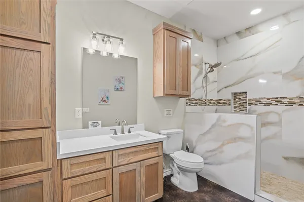 a bathroom with a sink a toilet and a mirror
