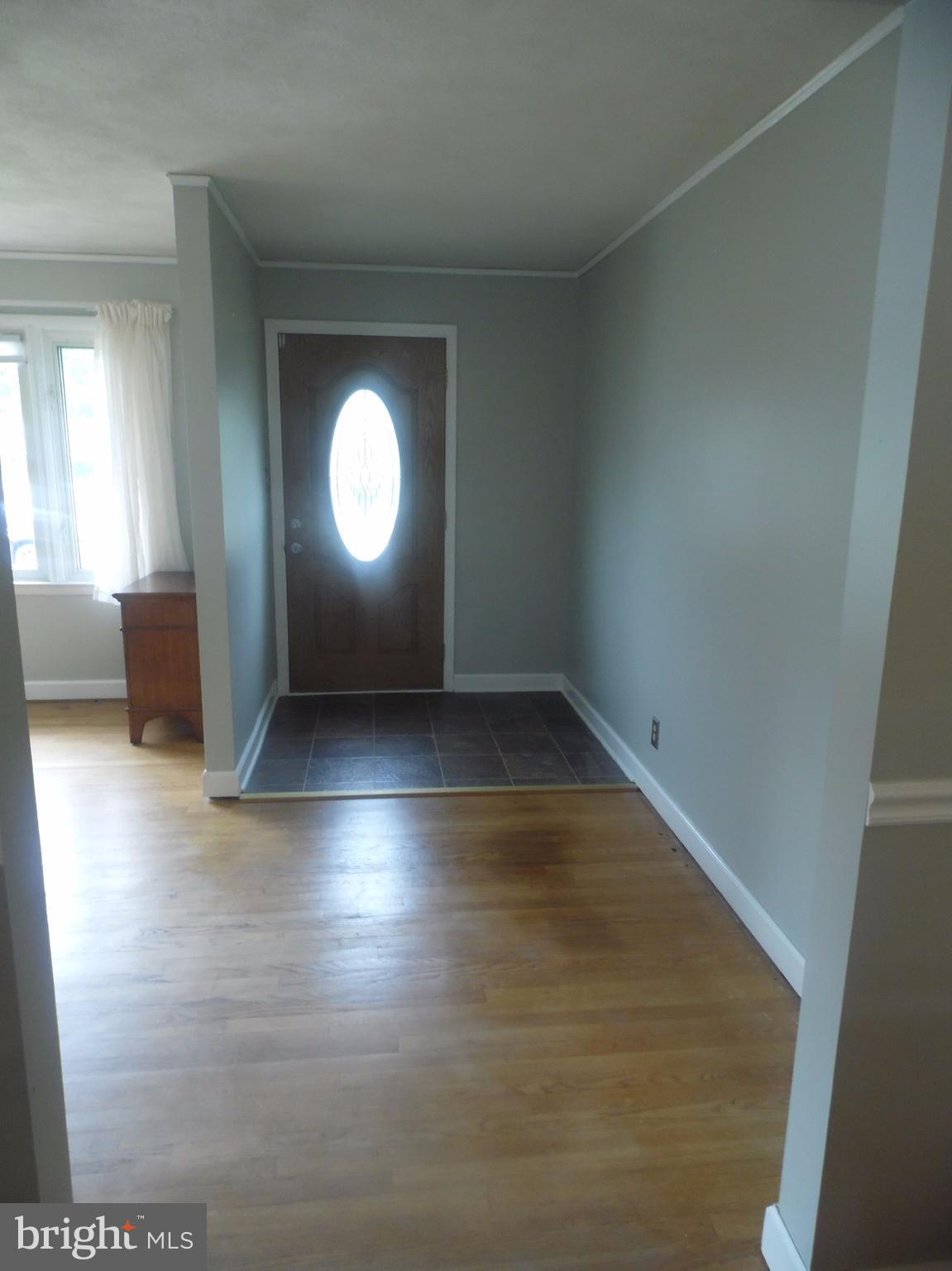2406 Windsor Road Baltimore, MD 21234 - Photo 2 of 20 an empty room with wooden floor and windows