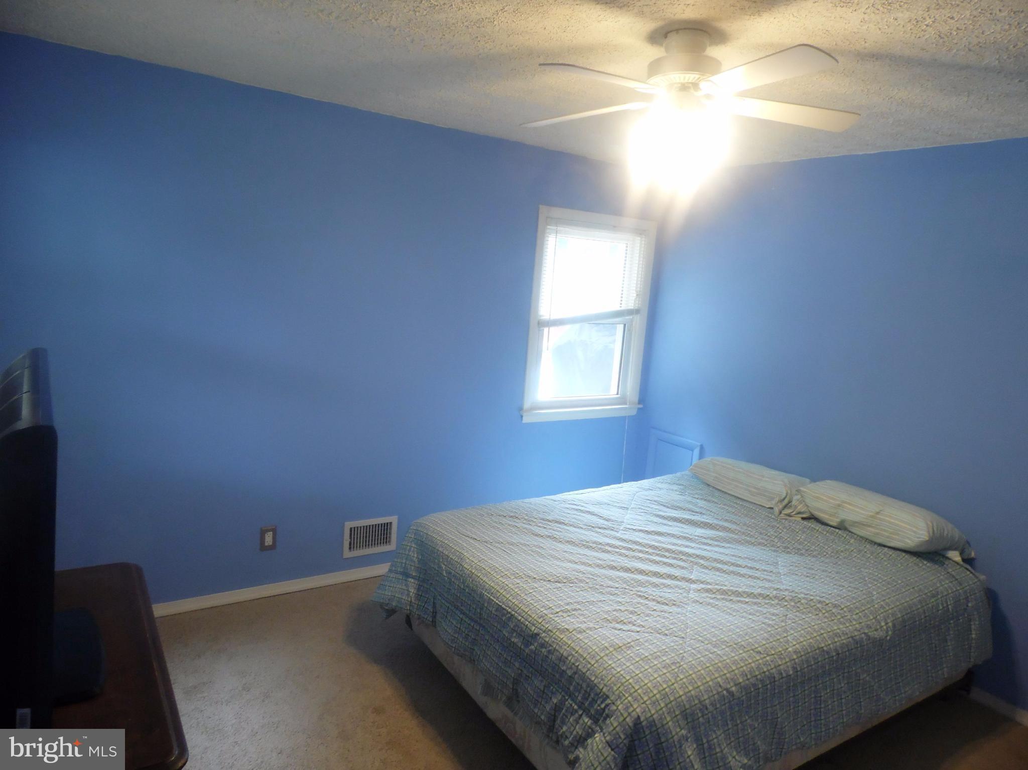 2406 Windsor Road Baltimore, MD 21234 - Photo 12 of 20 a bed sitting in a bedroom next to a window