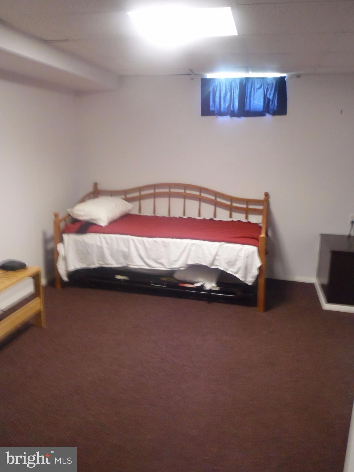 2406 Windsor Road Baltimore, MD 21234 - Photo 14 of 20 a bed sitting in a bedroom next to a larger window