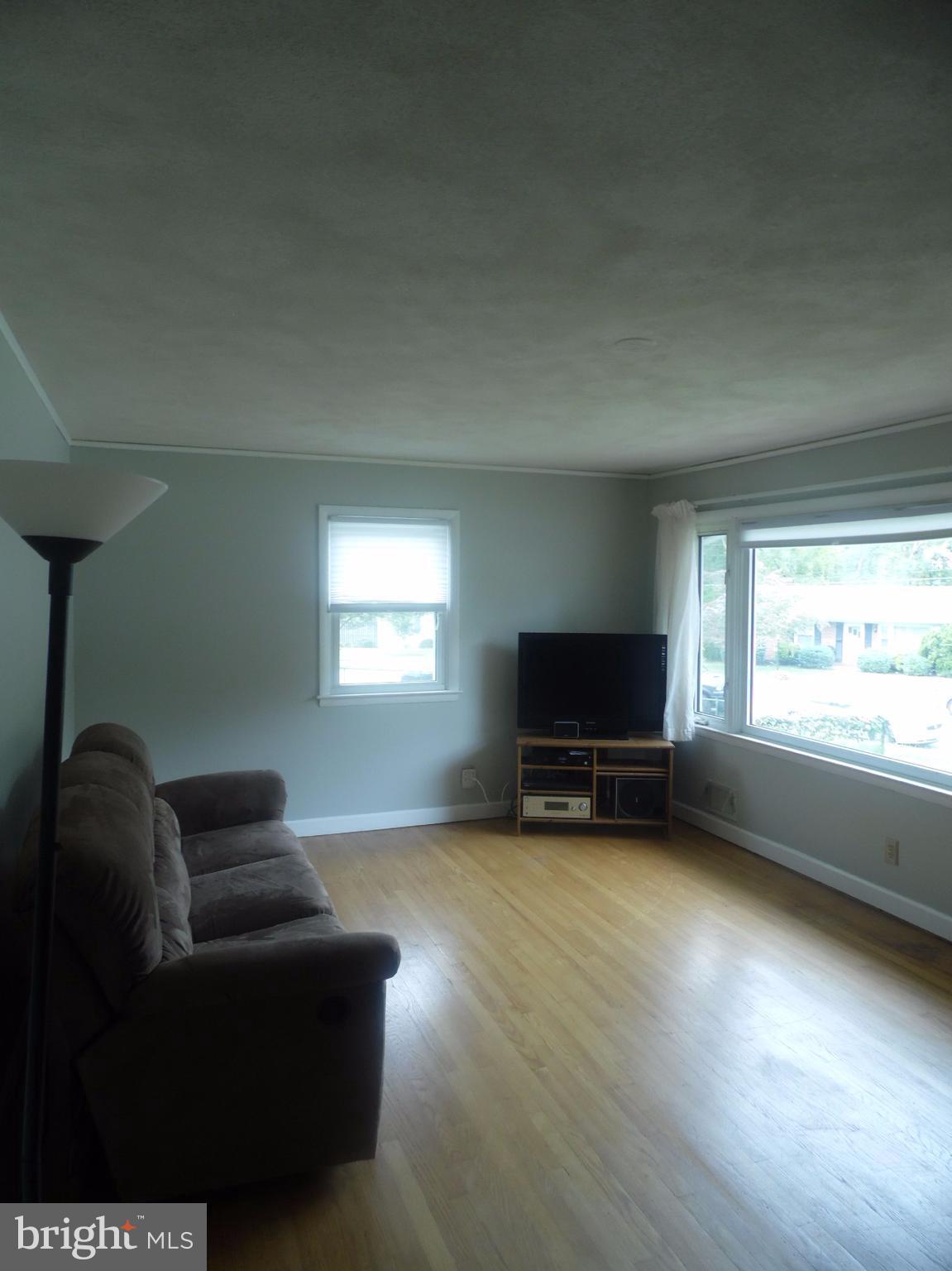 2406 Windsor Road Baltimore, MD 21234 - Photo 3 of 20 a living room with furniture and a flat screen tv