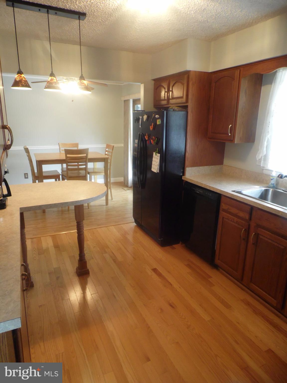 2406 Windsor Road Baltimore, MD 21234 - Photo 6 of 20 a kitchen with refrigerator and window