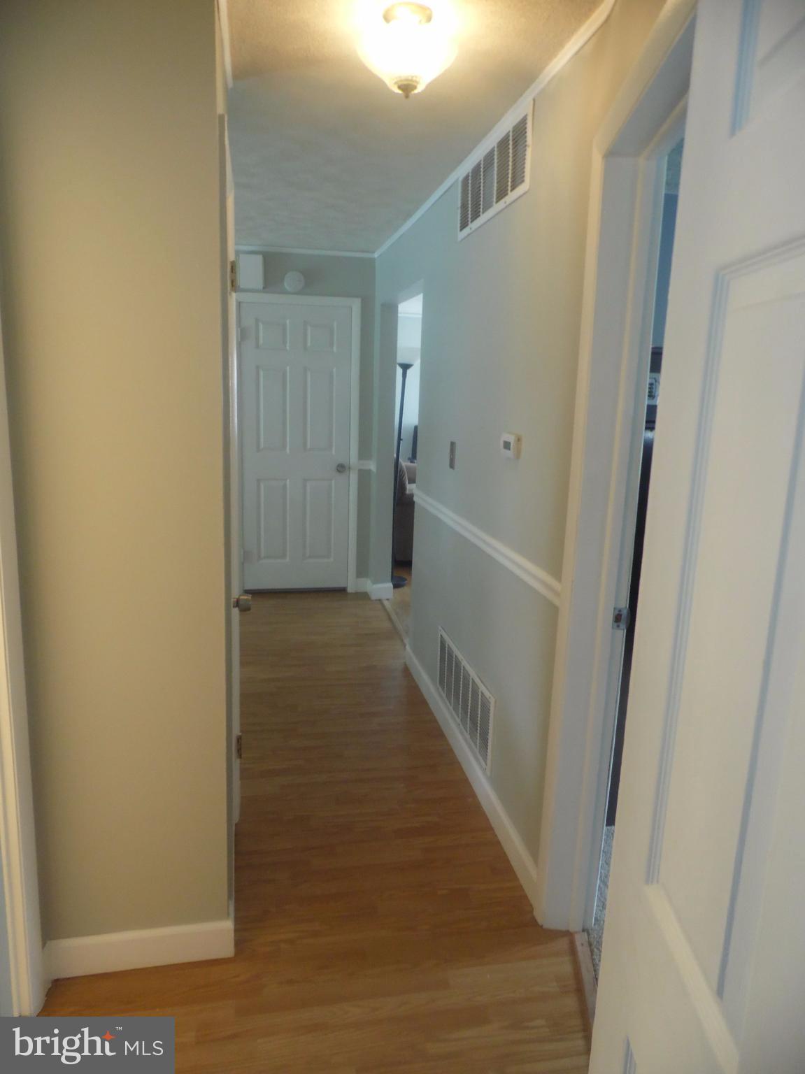 2406 Windsor Road Baltimore, MD 21234 - Photo 7 of 20 a view of a hallway with wooden floor