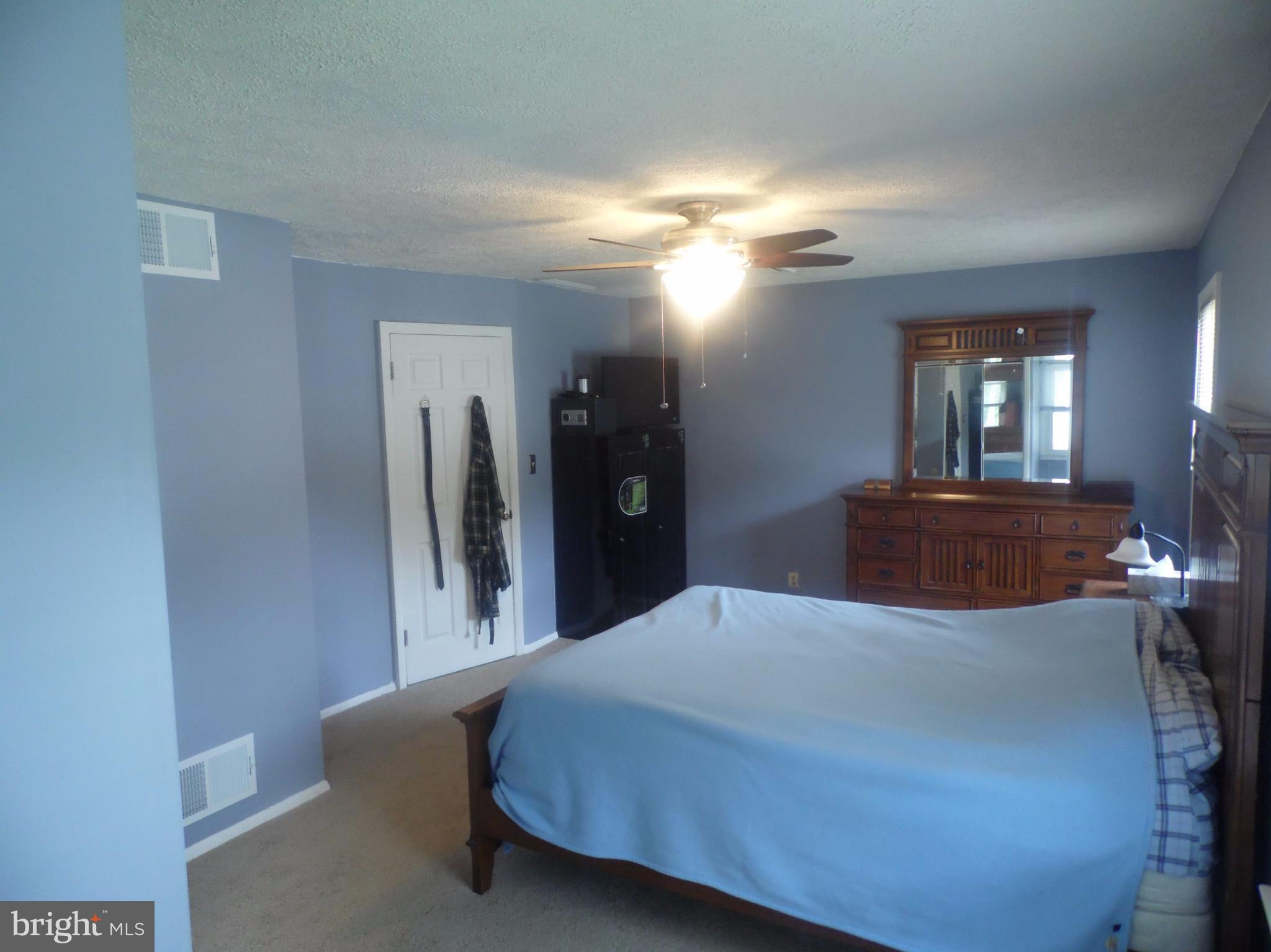 2406 Windsor Road Baltimore, MD 21234 - Photo 8 of 20 a bedroom with a bed and a large mirror