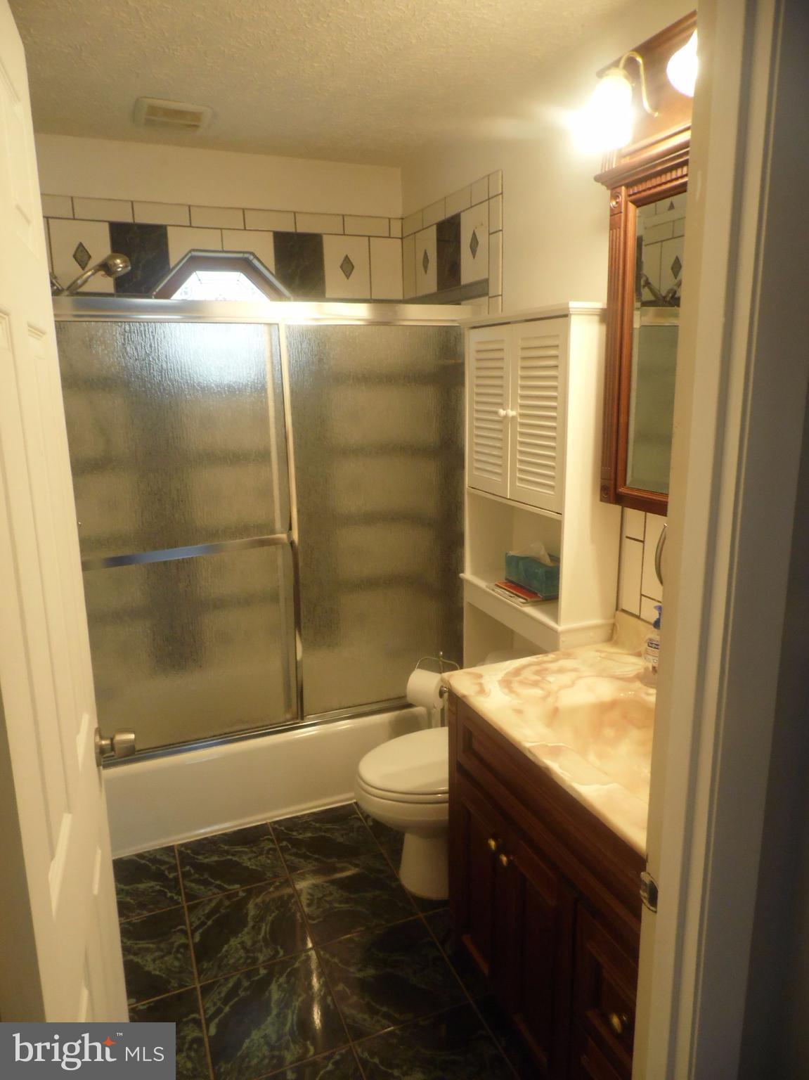 2406 Windsor Road Baltimore, MD 21234 - Photo 10 of 20 a bathroom with a granite countertop sink toilet and shower