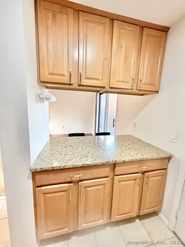 a kitchen with granite countertop cabinets and sink