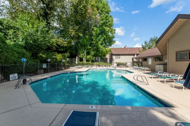 a view of a swimming pool with chairs