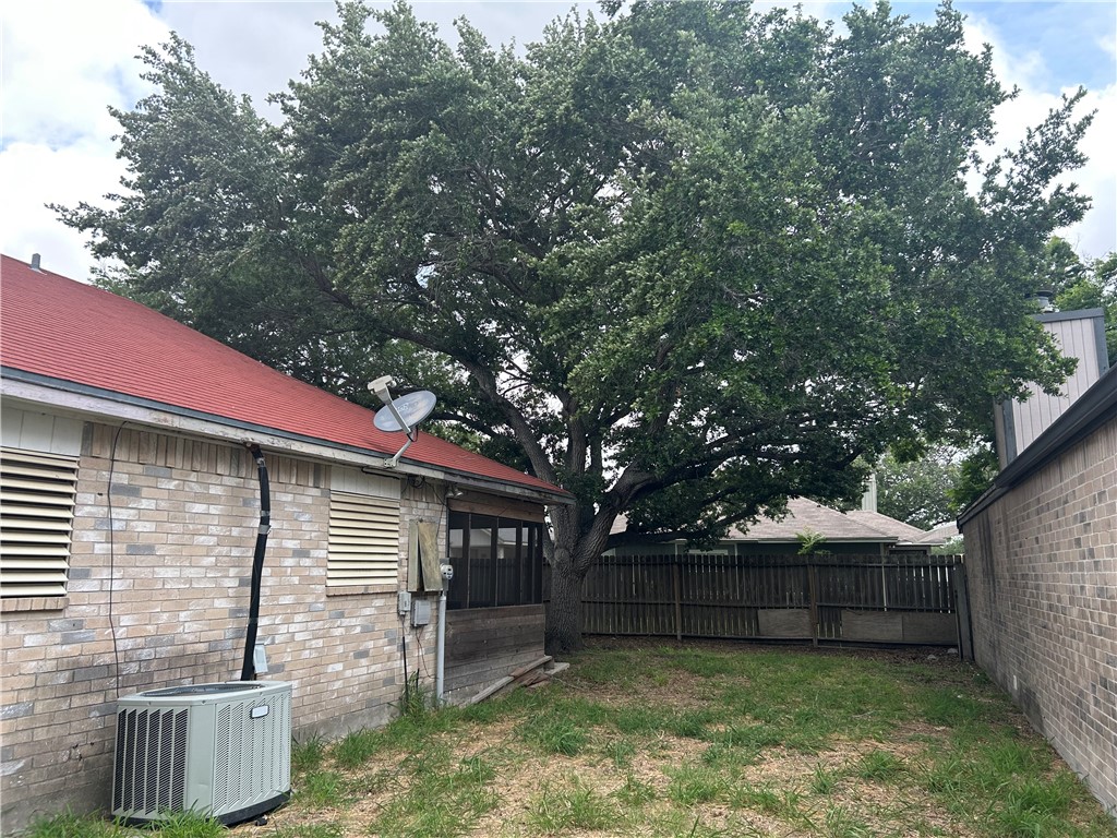 4530 Windows Drive Corpus Christi, TX 78413 - Photo 11 of 11 a view of a backyard with a large tree and wooden fence