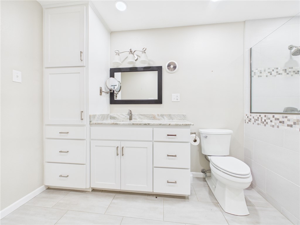 902 Briar Bend Court Bryan, TX 77802 - Photo 18 of 39 a bathroom with a toilet sink and mirror