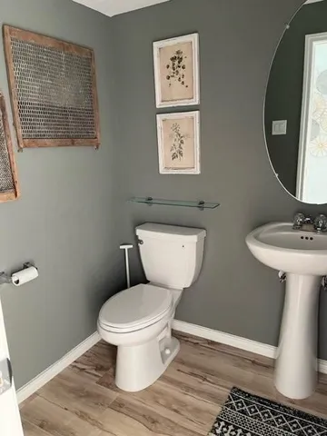 a white toilet sitting next to a bathroom sink