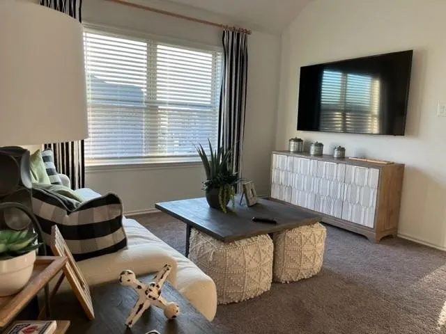 a living room with furniture and a flat screen tv