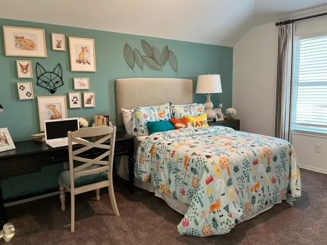 a bedroom with a bed and a desk