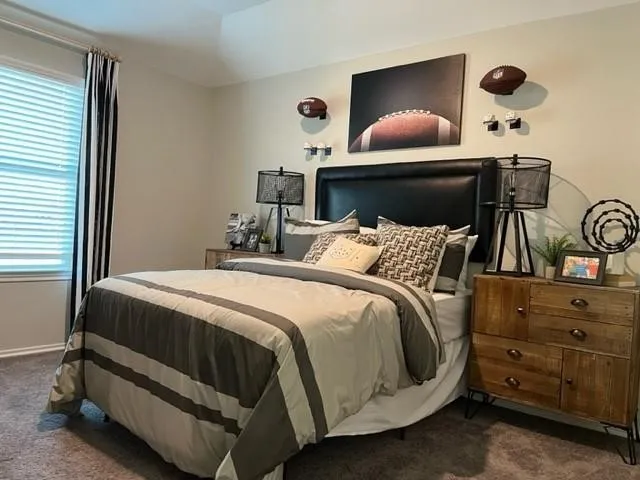 a bedroom with a bed and lamp