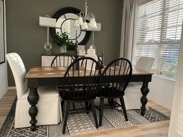 a view of a dining room with furniture and chandelier