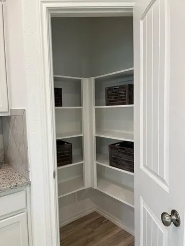 a living room with a fireplace and cabinets