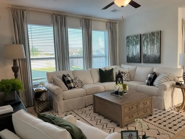 a living room with furniture and a large window