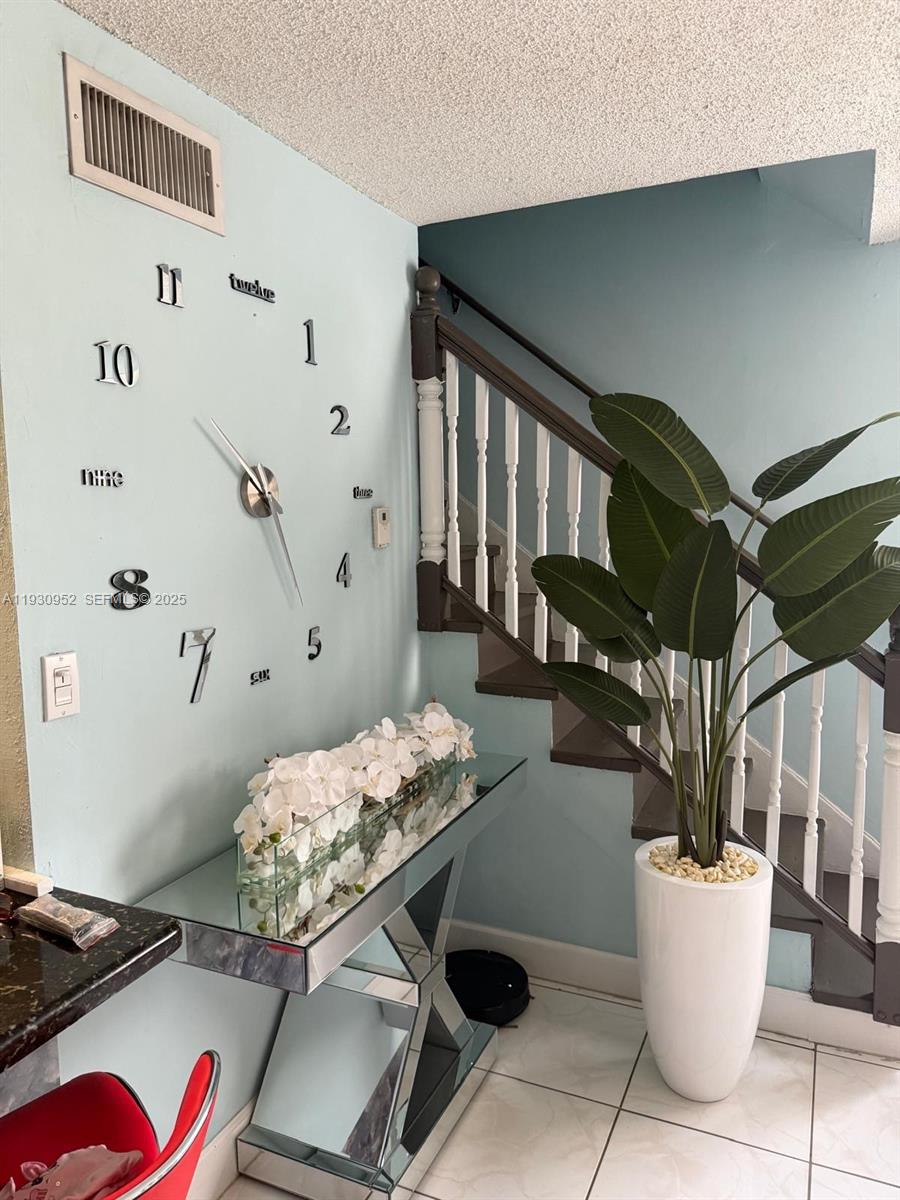 1255 West 53rd Street, Unit 301 Hialeah, FL 33012 - Photo 2 of 9 a living room with furniture and flowers