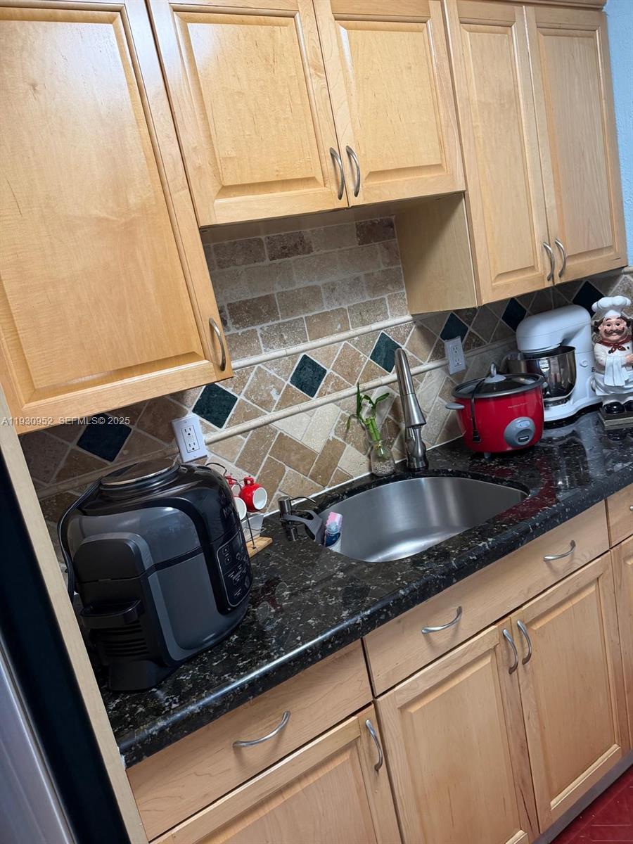 1255 West 53rd Street, Unit 301 Hialeah, FL 33012 - Photo 5 of 9 a kitchen with a sink and cabinets