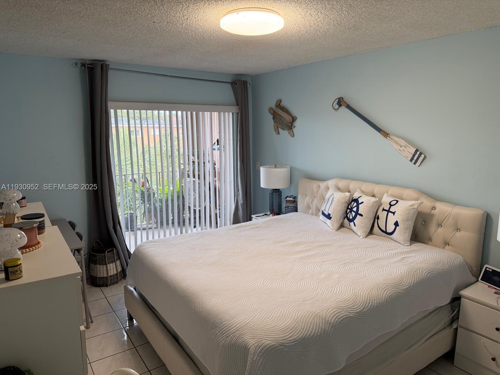 1255 West 53rd Street, Unit 301 Hialeah, FL 33012 - Photo 9 of 9 a bedroom with a bed and a window
