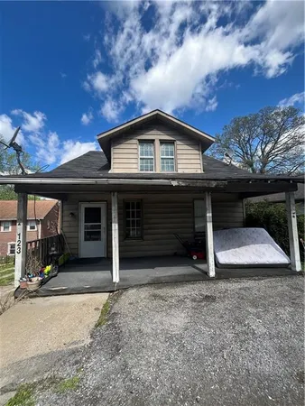 a view of a house with a balcony and garage