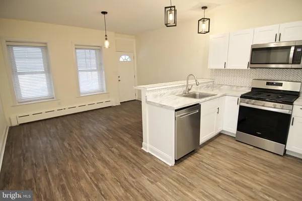 a bathroom with a sink mirror and toilet