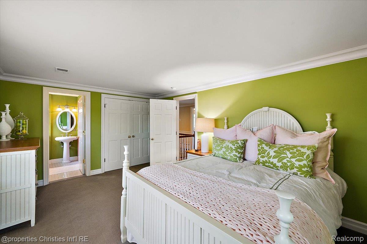 135 Clifton Road Bloomfield Hills, MI 48301 - Photo 46 of 77 Bedroom featuring green walls, crown molding, paneled bifold closet doors, and recessed lighting