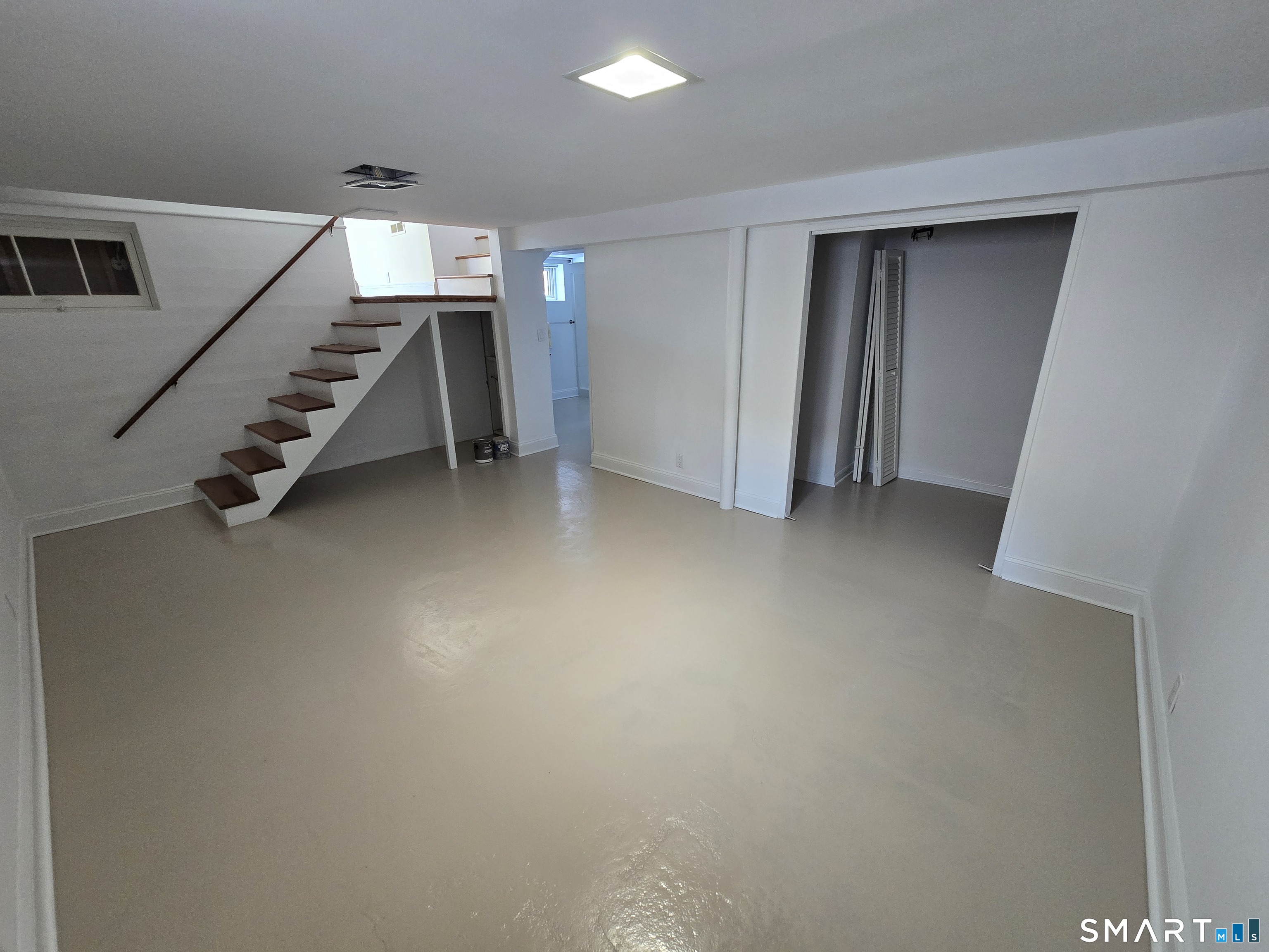 148 Catherine Street Fairfield, CT 06824 - Photo 15 of 25 a view of an empty room with stairs